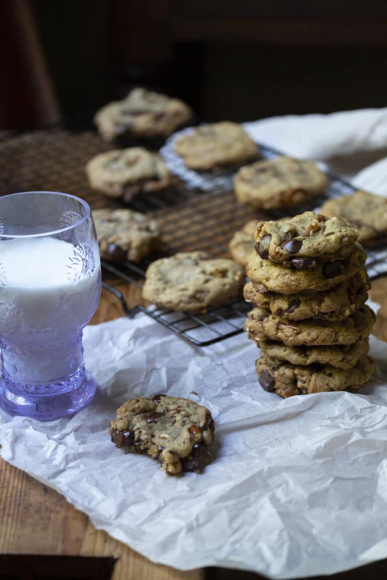 kitchen sink cookies in a stack next to a glass of milk