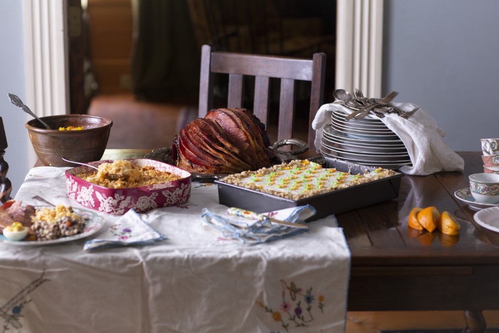 Easter dinner table with spread including southern baked ham