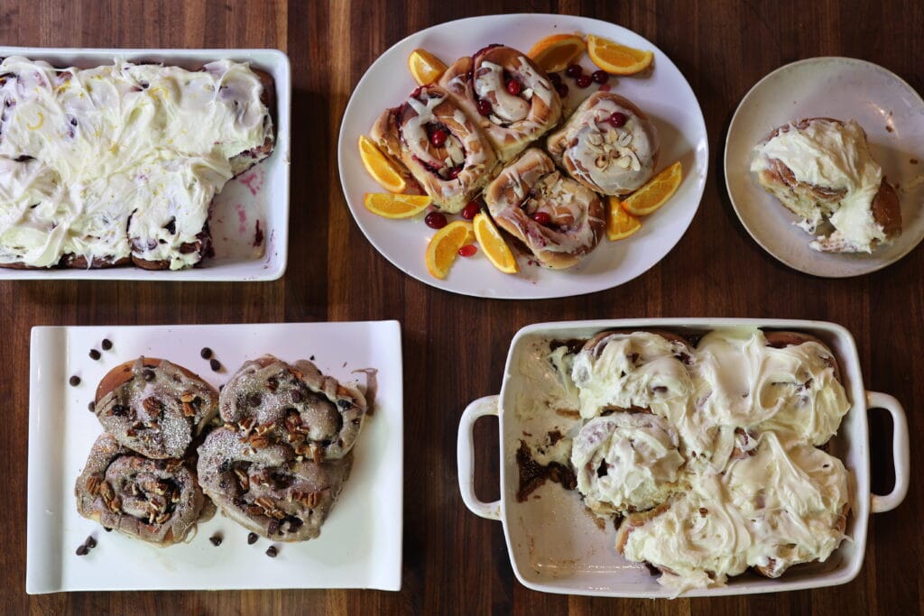 variety of homemade cinnamon, fruit and chocolate rolls on platters