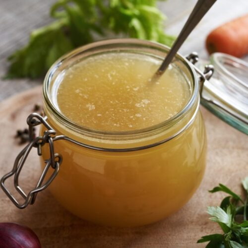 Chicken stock or chicken bone broth in glass jar