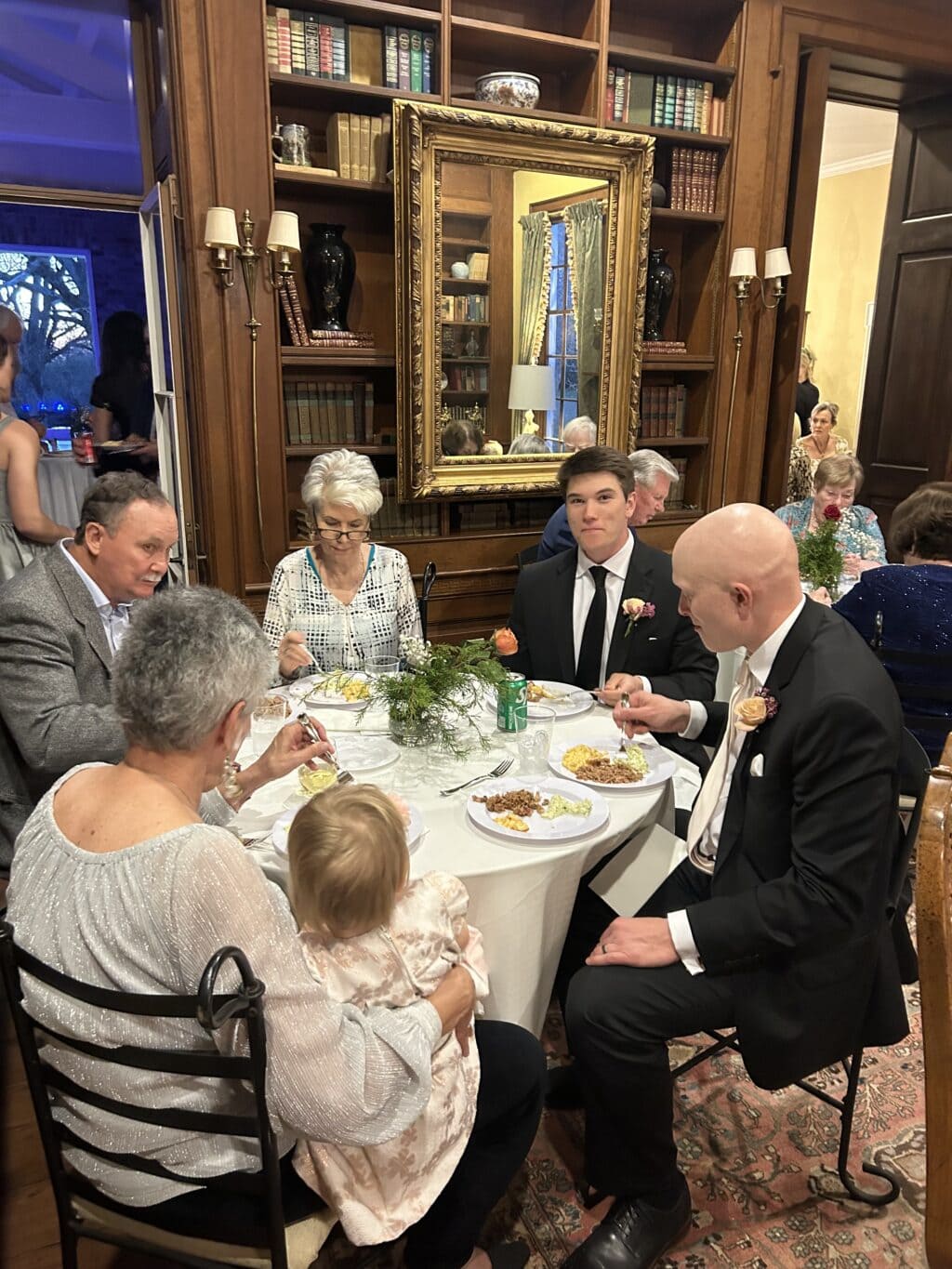 wedding reception dinner with mac and cheese and other delicious food - family eating at table