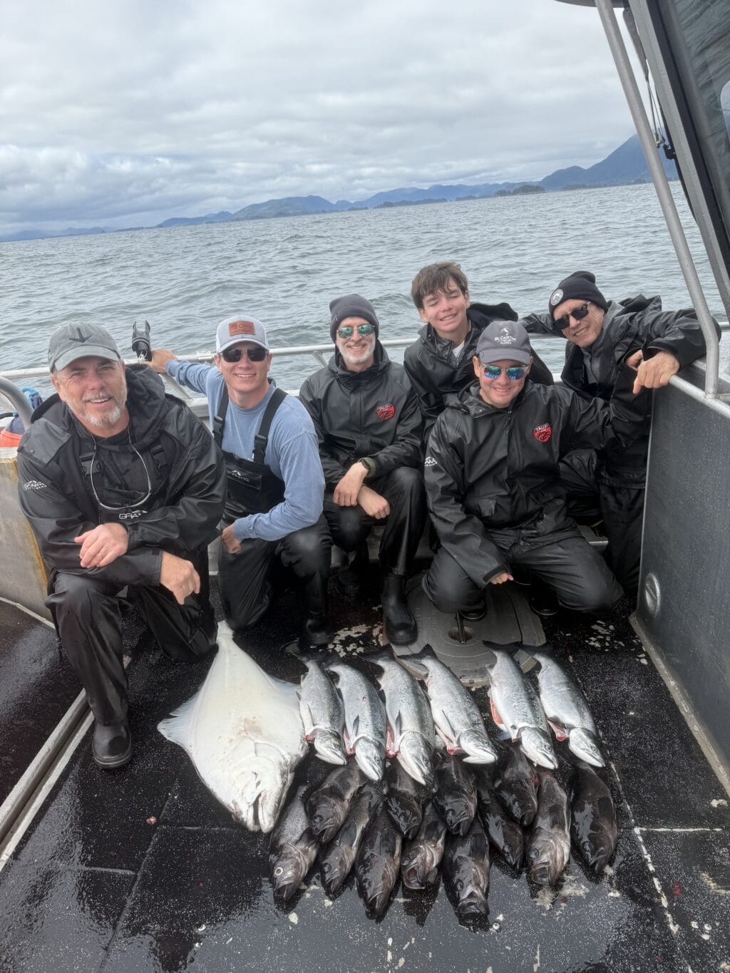 six people including Stacy Lyn, Scott, and Howlett together on fishing boat behind their catch