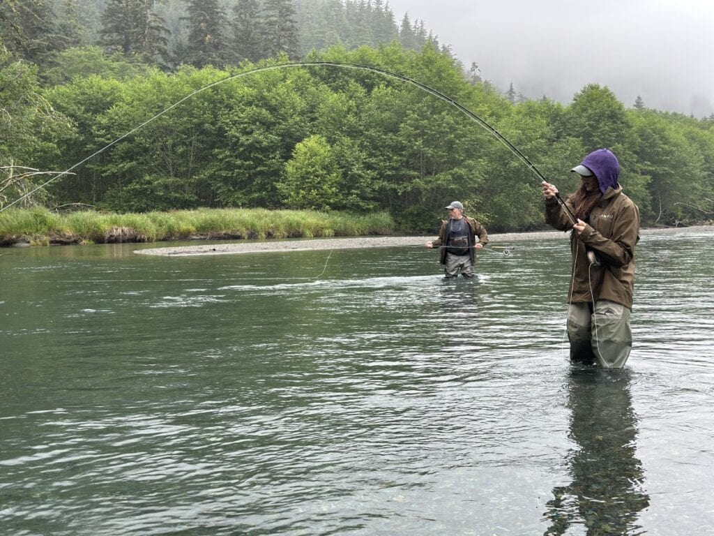 Stacy Lyn and Scott in river near Sitka, fly fishing