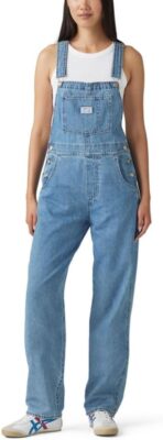 young woman in vintage denim gardening overalls