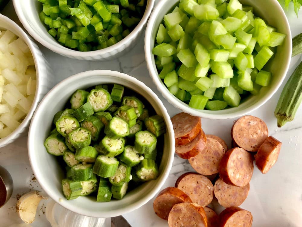ingredients for authentic gumbo - celery, onions, green peppers, okra, sausage