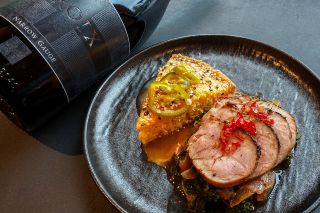 black plate holding blackened pork loin elegantly served at Alaskan lodge