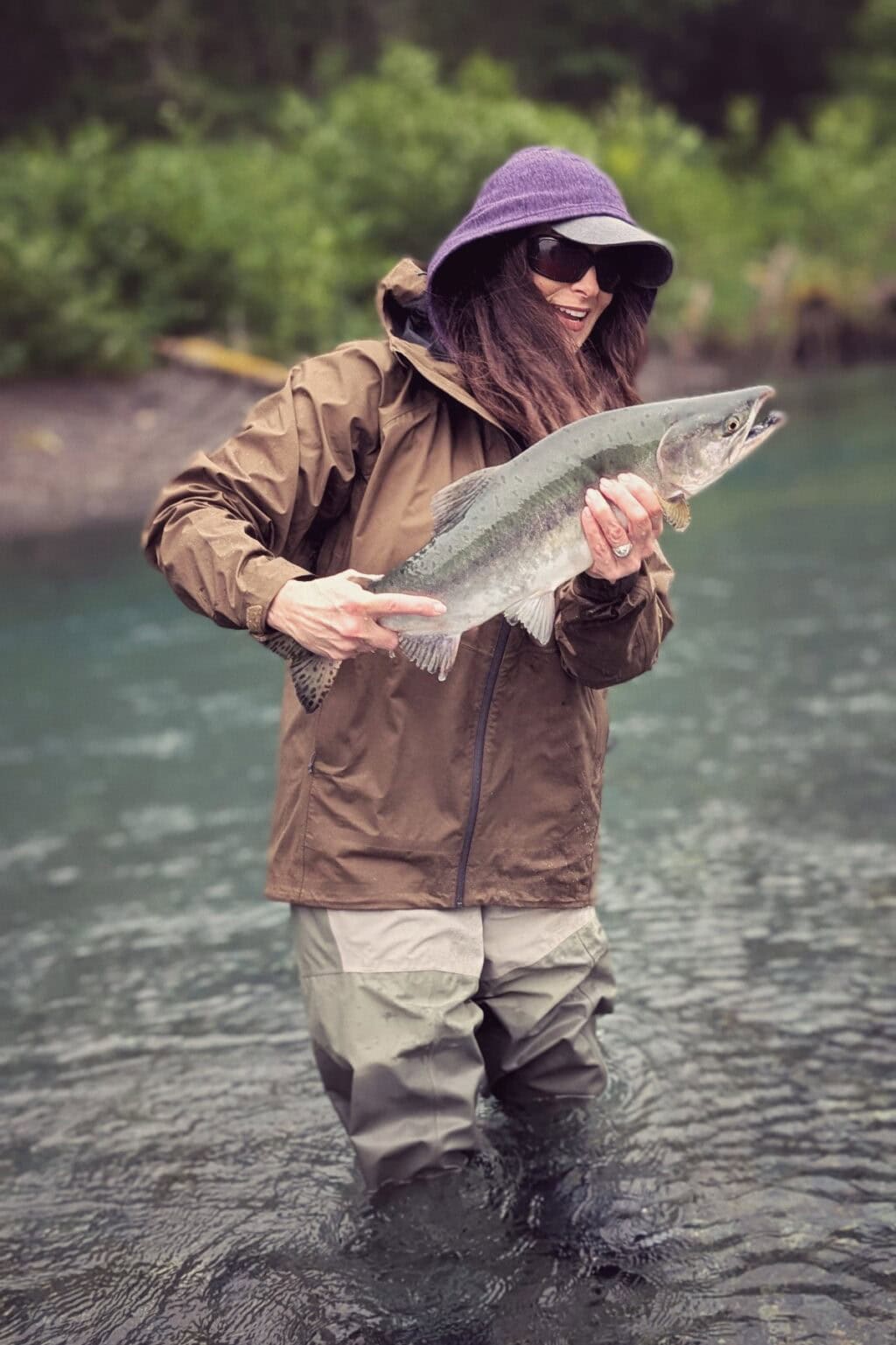 Stacy Lyn holding up large fish caught fly fishing during Alaska trip