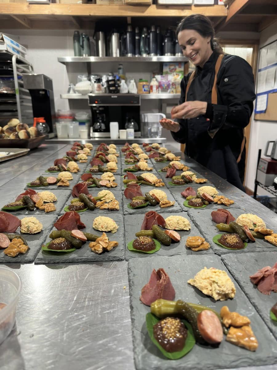 Stacy Lyn as chef at lodge preparing charcuterie boards