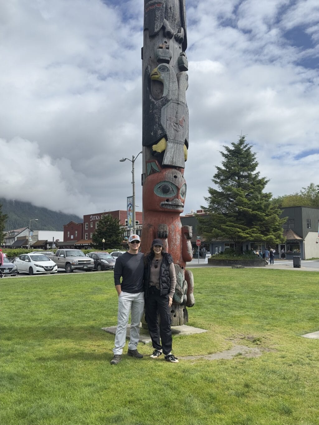 Stacy Lyn and Howlett standing in front of totem pole