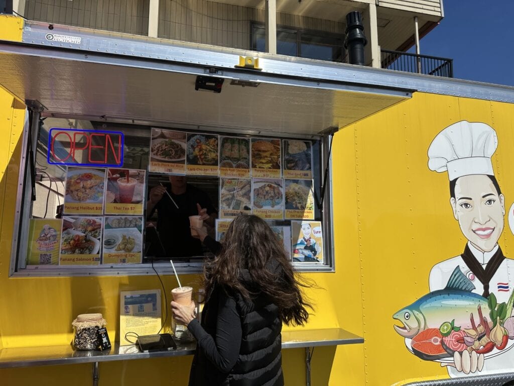 Stacy Lyn ordering shakes at bright yellow seafood shack in Sitka Alaska