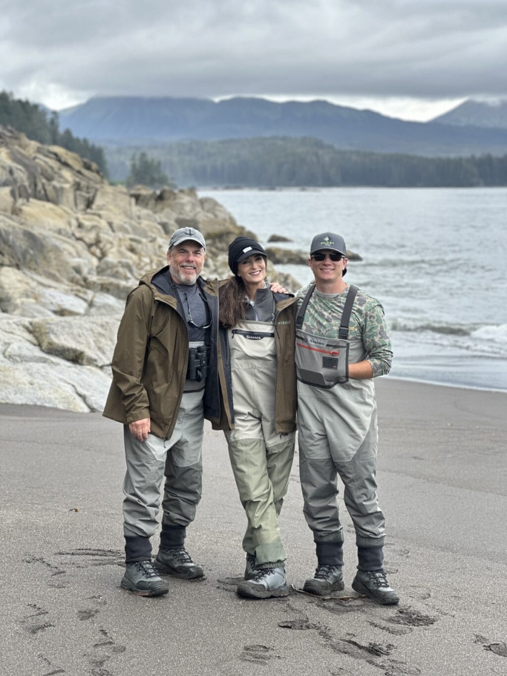 Scott, Stacy Lyn, and Howlett on Alaska shore in fishing gear