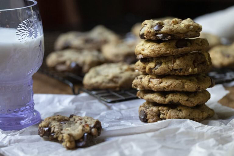 stacked kitchen sink cookies with glass of milk