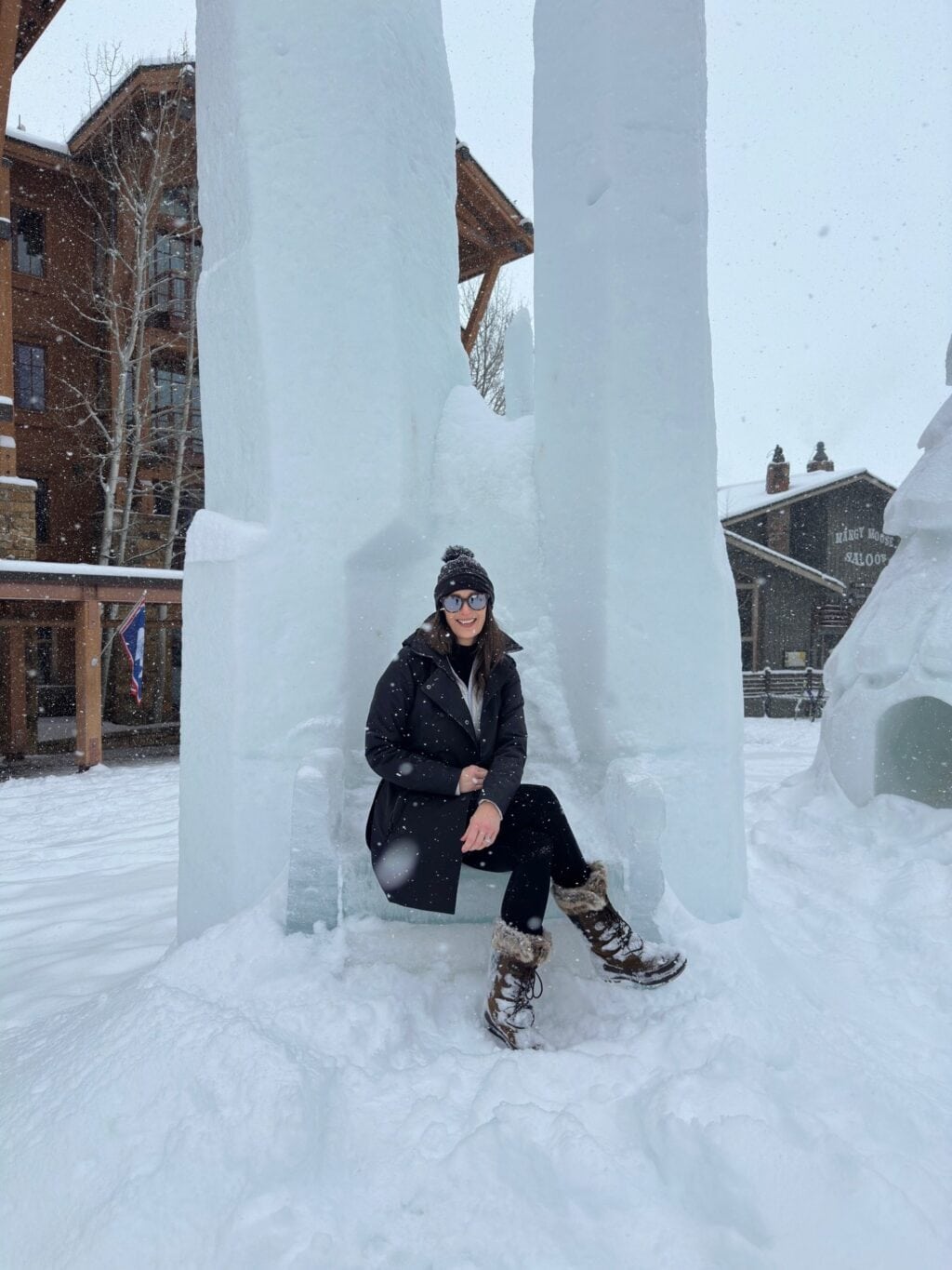 Stacy Lyn sitting outside Jackson Hole lodge on anniversary trip