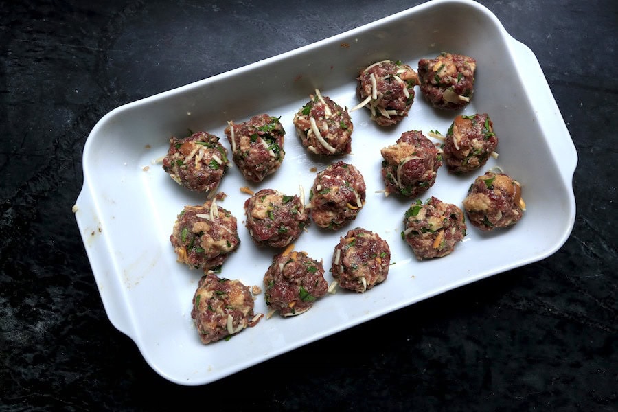 meatballs arranged in white casserole pan