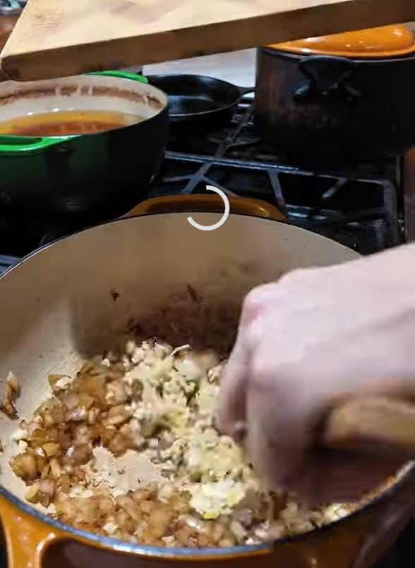 sauteeing onions and garlic in Dutch oven for tomato sauce