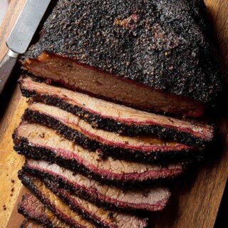 succulent smoked brisket sliced on wooden cutting board
