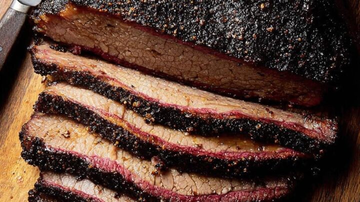 succulent smoked brisket sliced on wooden cutting board