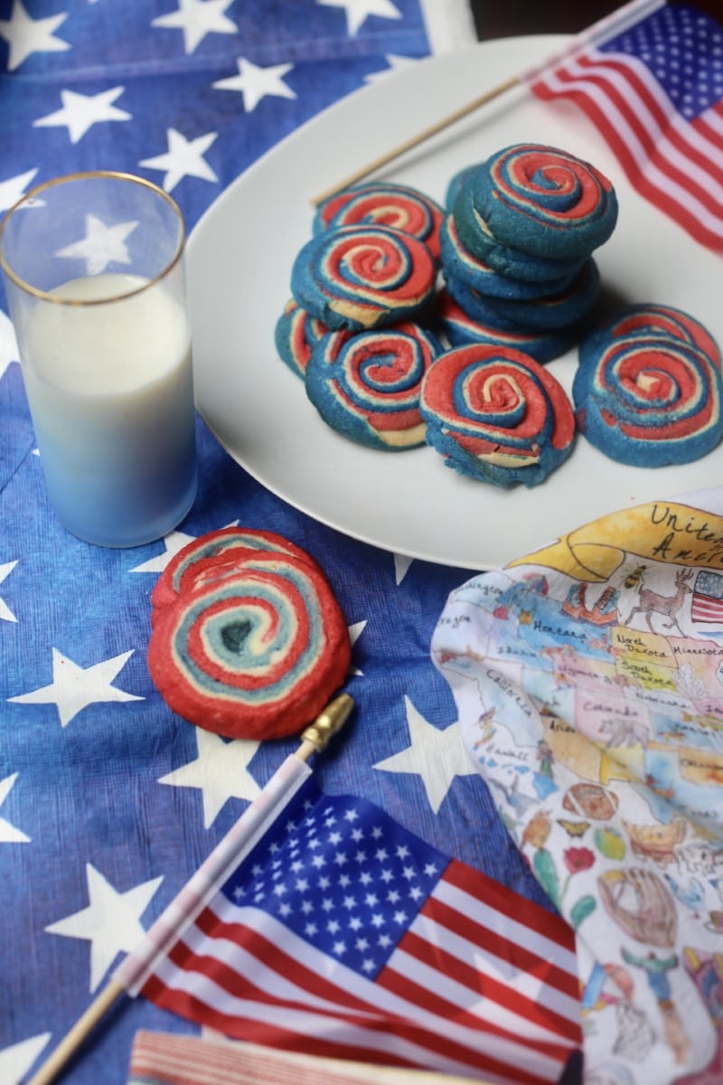 Colorful patriotic pinwheel cookies with American flag and milk for Independence Day.